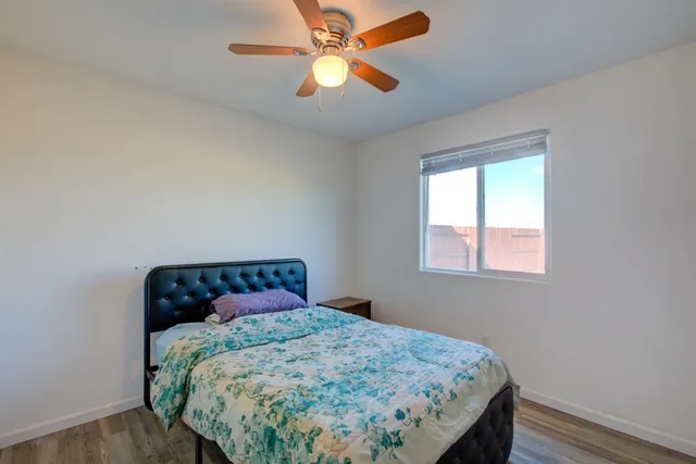 a bedroom with a bed and a window