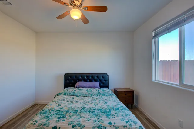 a bedroom with a bed and a window