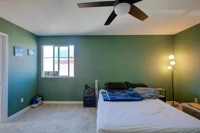 a bedroom with a bed and window