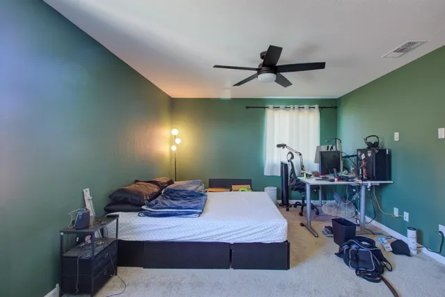 a bedroom with a bed and a chandelier