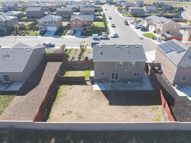 an aerial view of a house with a swimming pool