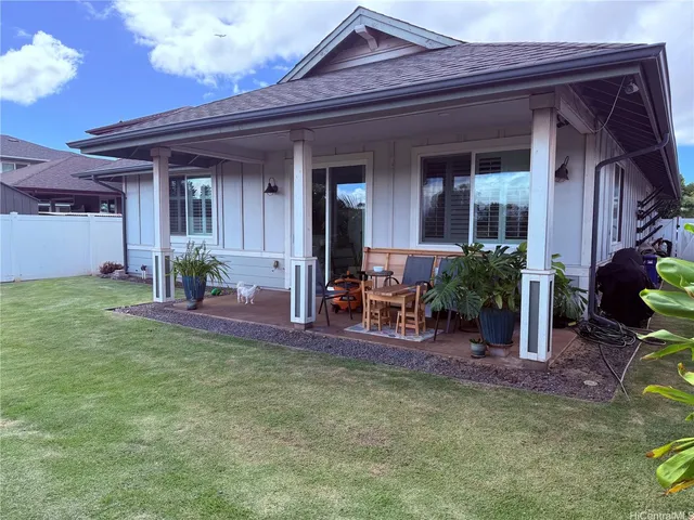 a view of a porch with a table and chairs