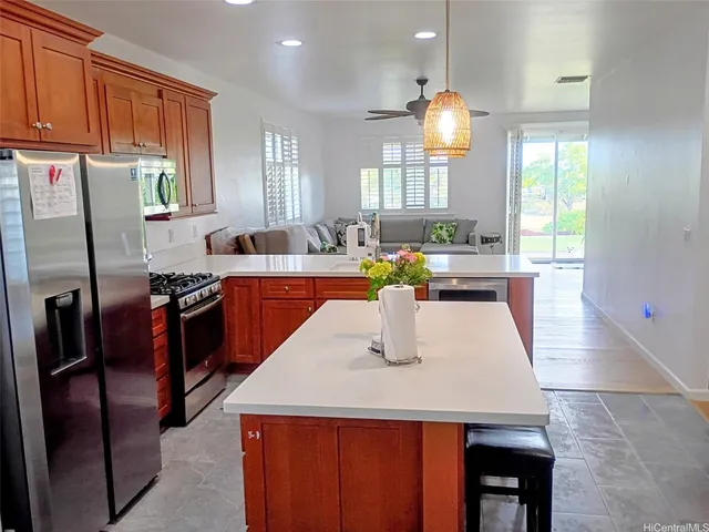 a kitchen with stainless steel appliances granite countertop a sink a stove and a refrigerator