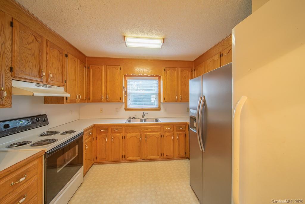 4525 Hickory Grove Road Sharon, SC 29742 - Photo 9 of 35 a kitchen with stainless steel appliances granite countertop a sink stove and refrigerator