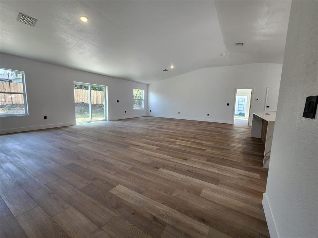 1032 Concert Avenue Spring Hill, FL 34609 - Photo 16 of 35 an empty room with wooden floor and windows