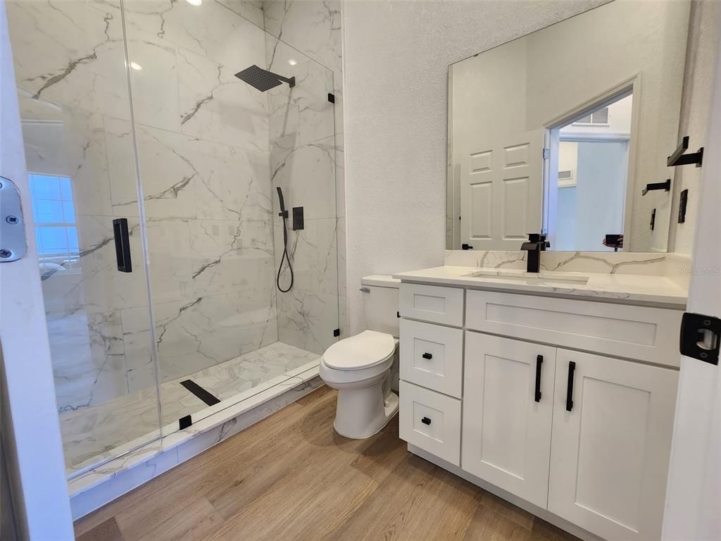 1032 Concert Avenue Spring Hill, FL 34609 - Photo 18 of 35 a bathroom with a double vanity sink toilet and shower