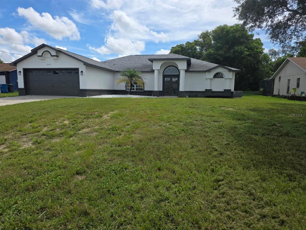 1032 Concert Avenue Spring Hill, FL 34609 - Photo 2 of 35 a front view of a house with garden