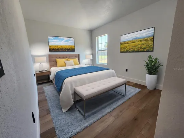 a bedroom with a bed and wooden floor