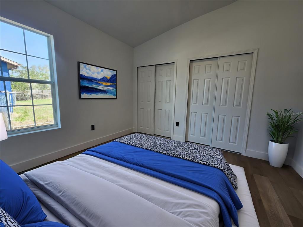 1032 Concert Avenue Spring Hill, FL 34609 - Photo 24 of 35 a bed sitting in a bedroom next to a window