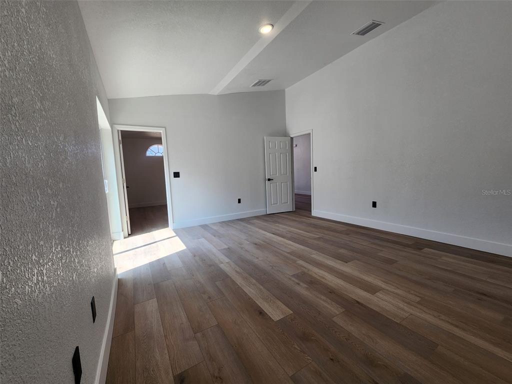 1032 Concert Avenue Spring Hill, FL 34609 - Photo 28 of 35 a view of an empty room with wooden floor