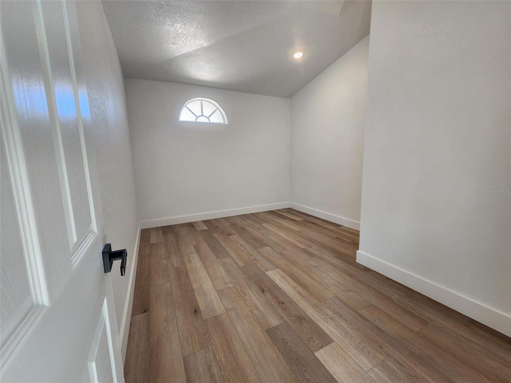 1032 Concert Avenue Spring Hill, FL 34609 - Photo 29 of 35 an empty room with wooden floor and windows