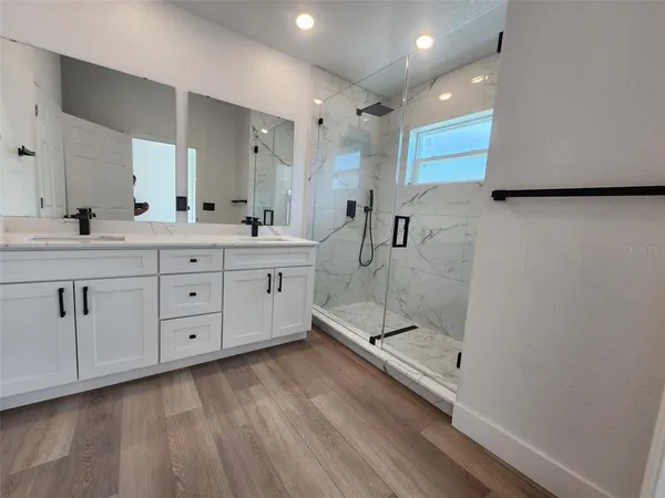 a bathroom with a double vanity sink and mirror