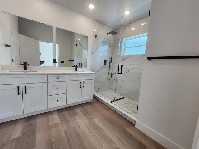 a bathroom with a double vanity sink and mirror