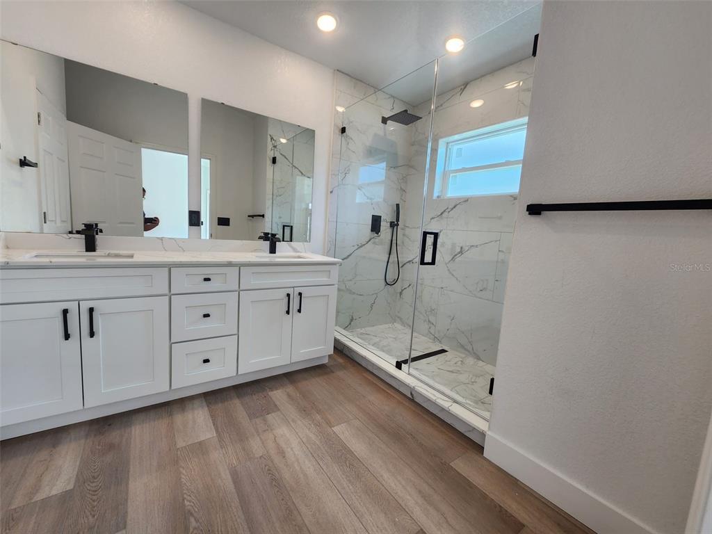 1032 Concert Avenue Spring Hill, FL 34609 - Photo 33 of 35 a bathroom with a double vanity sink and mirror