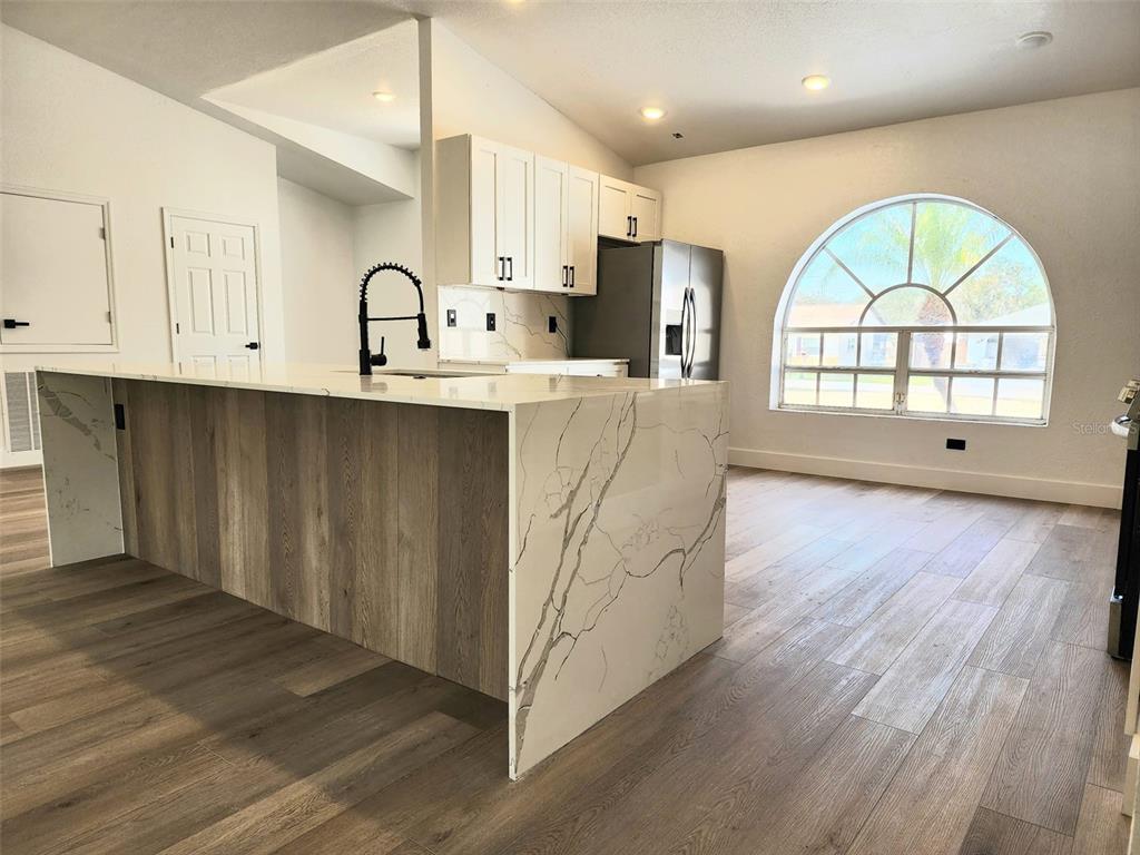 1032 Concert Avenue Spring Hill, FL 34609 - Photo 7 of 35 a view of kitchen with wooden floors and a window