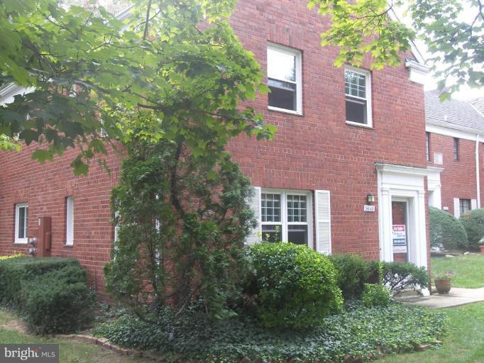 3648 Gunston Road Alexandria, VA 22302 - Photo 12 of 12 a red brick house with trees in front of it