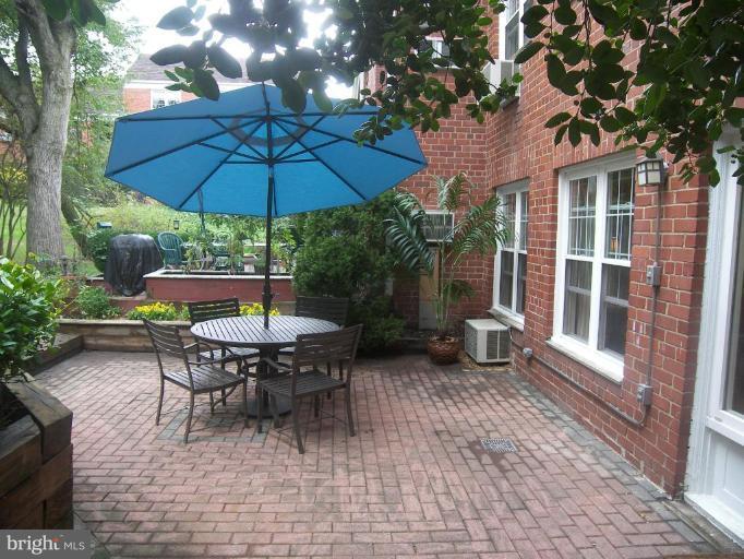 3648 Gunston Road Alexandria, VA 22302 - Photo 8 of 12 a view of a patio with a table and chairs under an umbrella