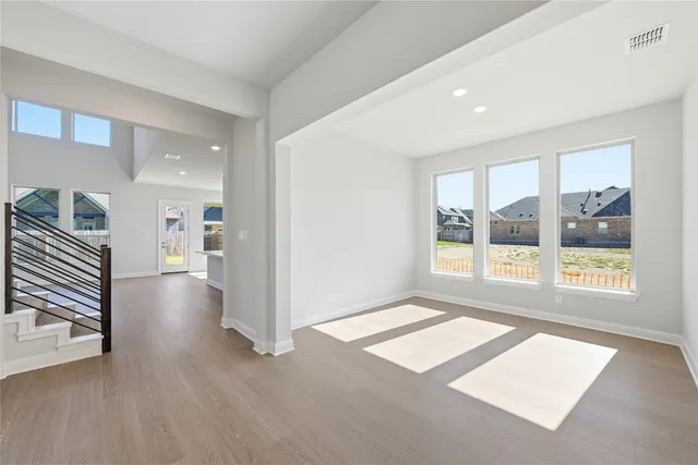 a view of livingroom with furniture staircase and windows