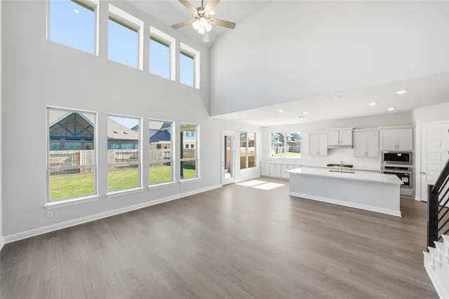 a large white kitchen with lots of counter top space a sink and appliances