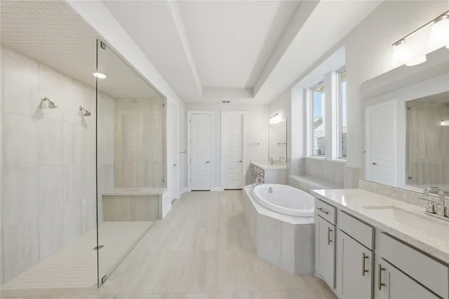 a bathroom with a double vanity sink toilet and shower