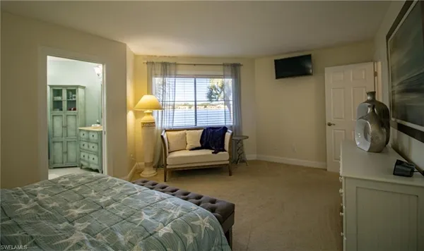 a bedroom with a bed couch and a window