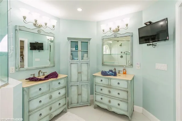 a bathroom with a double vanity sink mirror and window