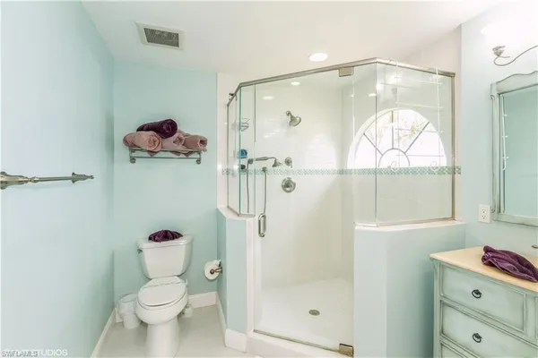 a bathroom with a shower a toilet and a sink