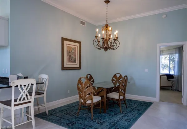 a view of a dining room with furniture and chandelier