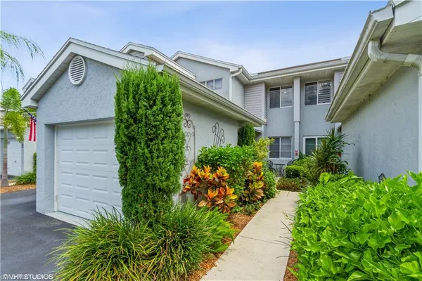 a view of a house with potted plants
