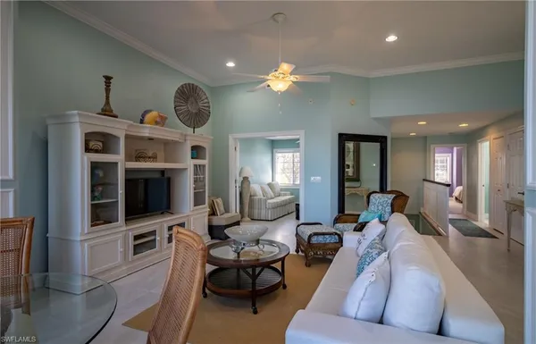 a living room with furniture a large window and a flat screen tv