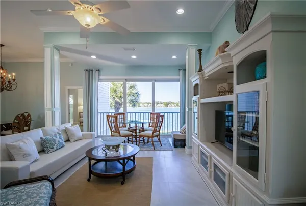a living room with fireplace furniture and a large window
