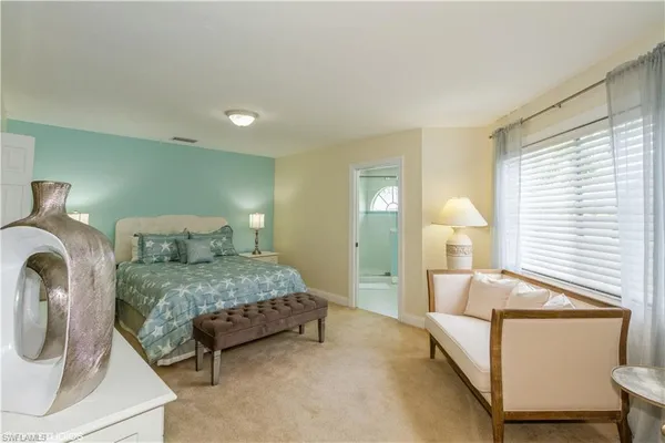 a bedroom with a bed and window