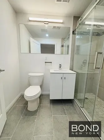 a bathroom with a toilet sink and shower