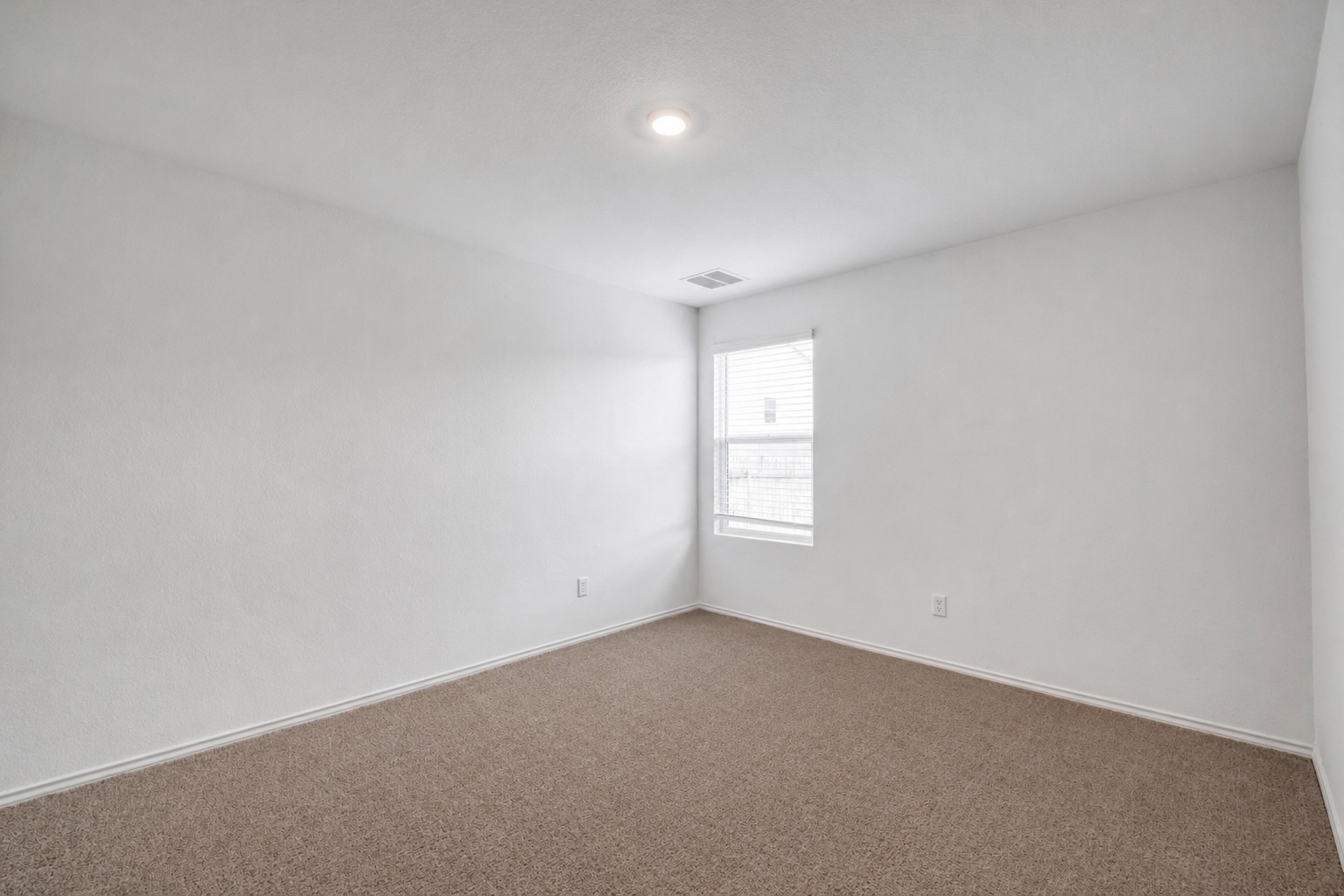 23412 Tiny Moons Way Elgin, TX 78621 - Photo 21 of 38 Carpeted room featuring a single window, recessed lighting, and white baseboards
