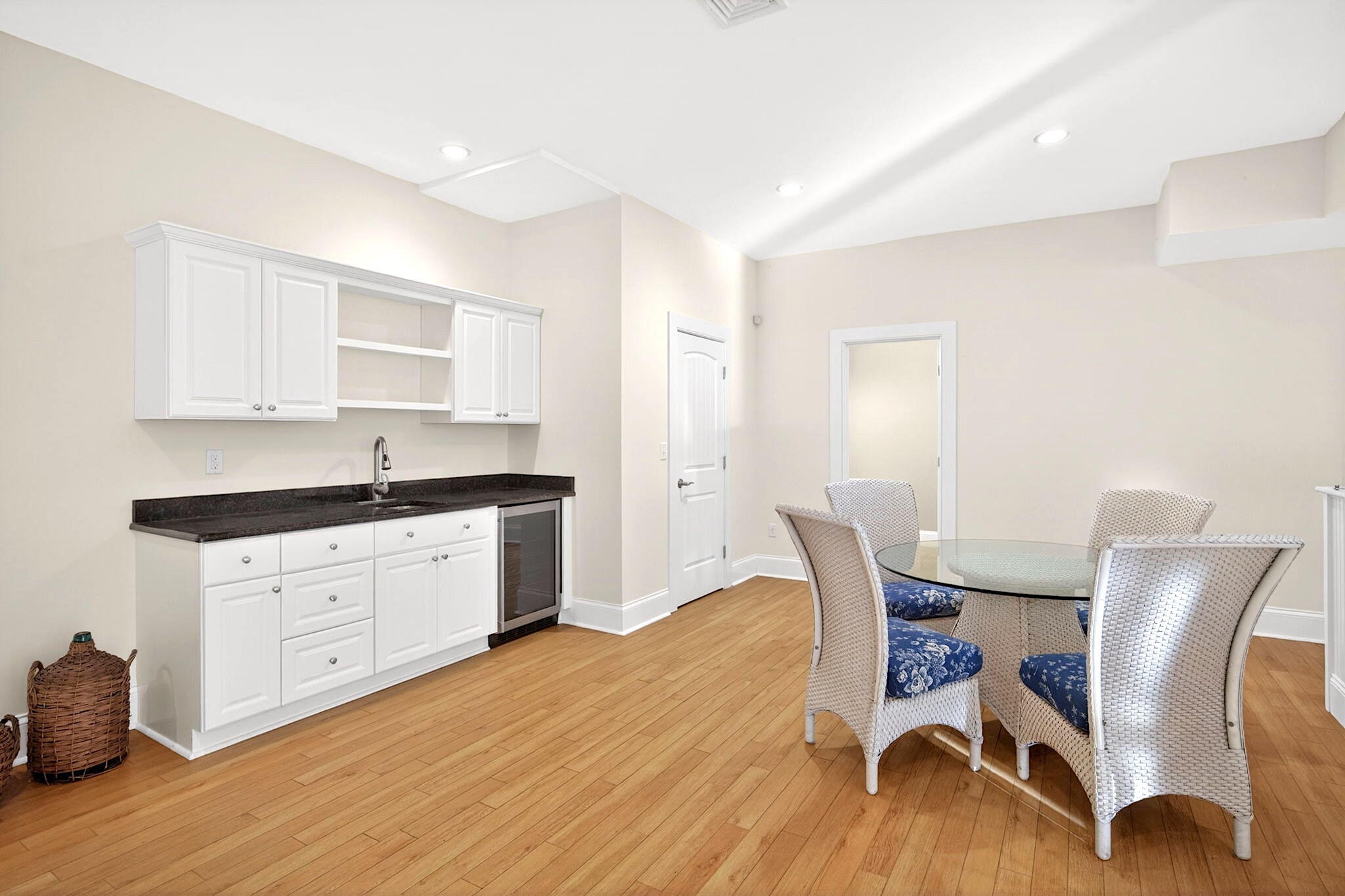 205 Little River Road Cotuit, MA 02635 - Photo 34 of 60 a kitchen with granite countertop white cabinets chairs and wooden floor