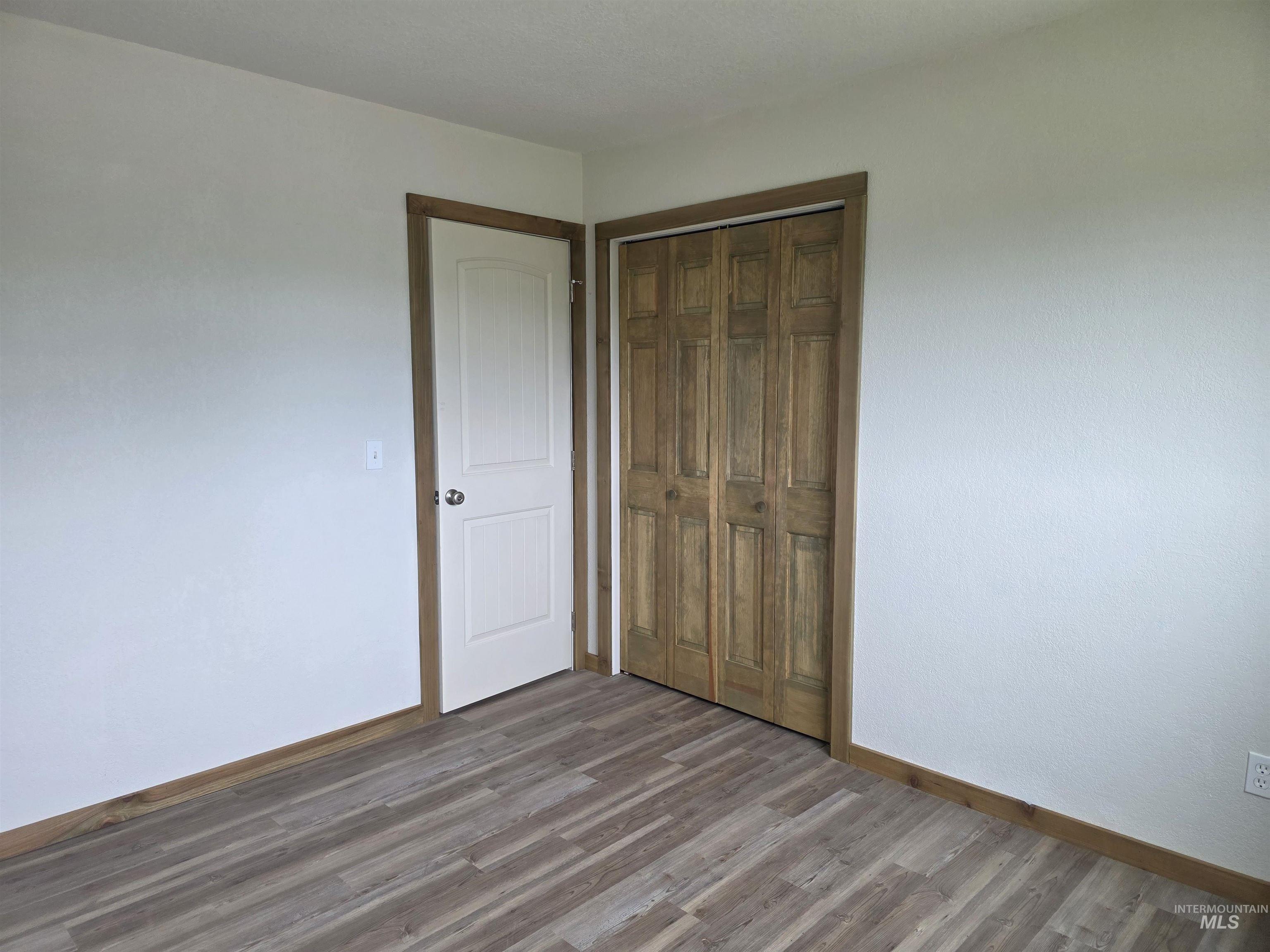 310 Fir Road Kamiah, ID 83536 - Photo 22 of 32 Neutral wall finishes with contrasting wood-finish trim and wood-finish flooring