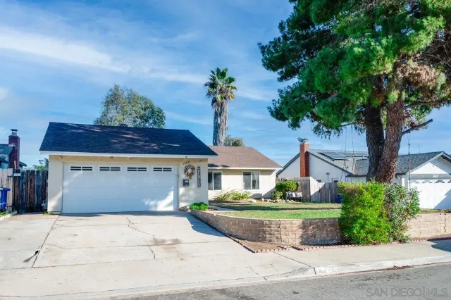 a front view of a house with a garden and a yard