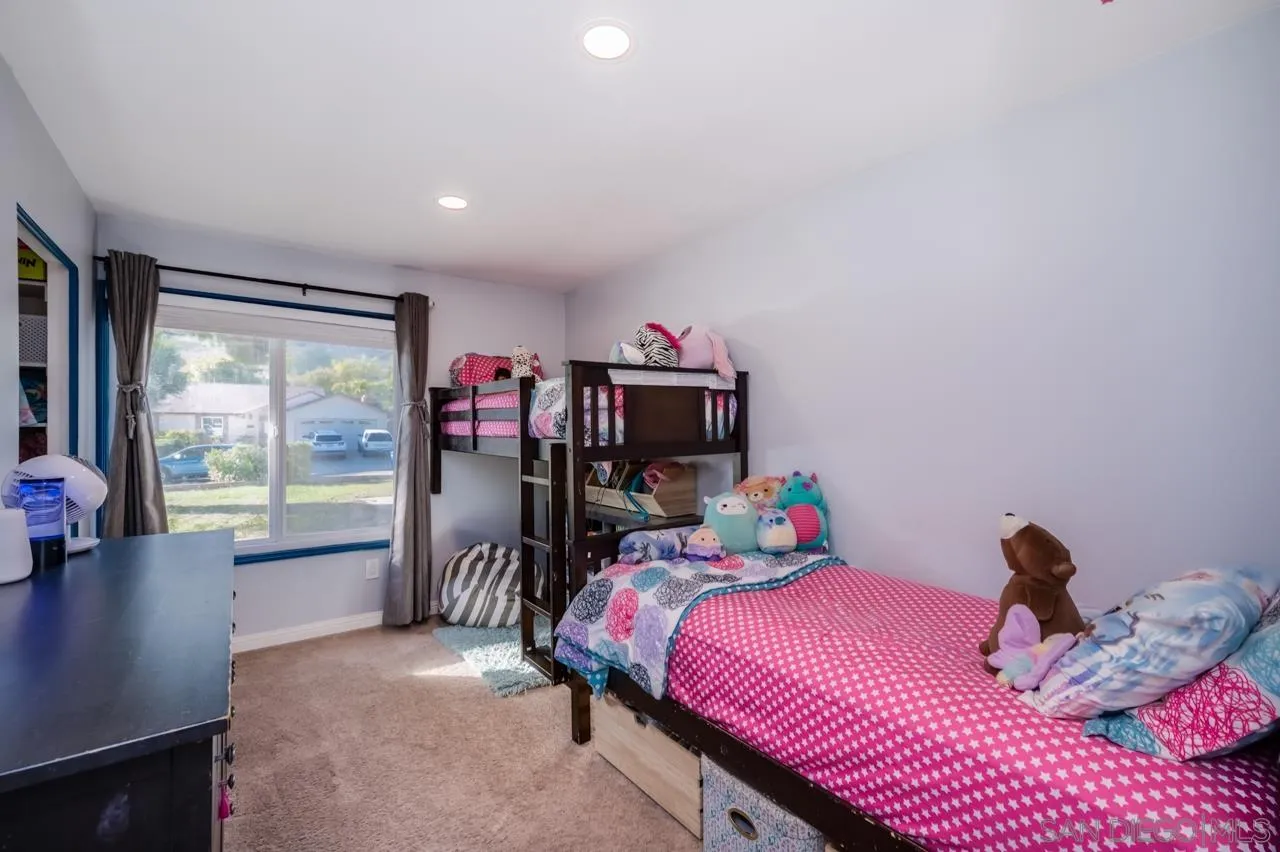 14027 Hermosillo Way Poway, CA 92064 - Photo 15 of 31 a bedroom with a bed and large windows