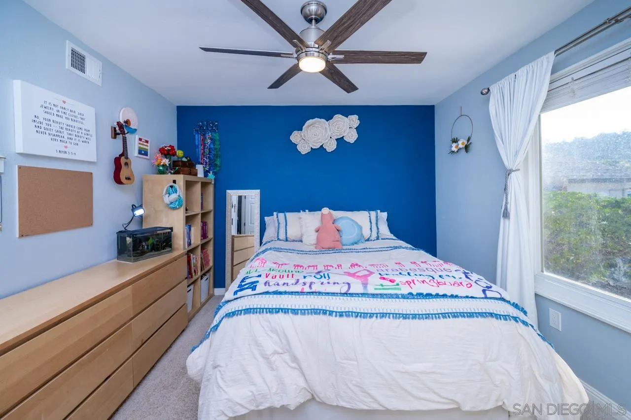 14027 Hermosillo Way Poway, CA 92064 - Photo 18 of 31 a bedroom with a bed and a chandelier