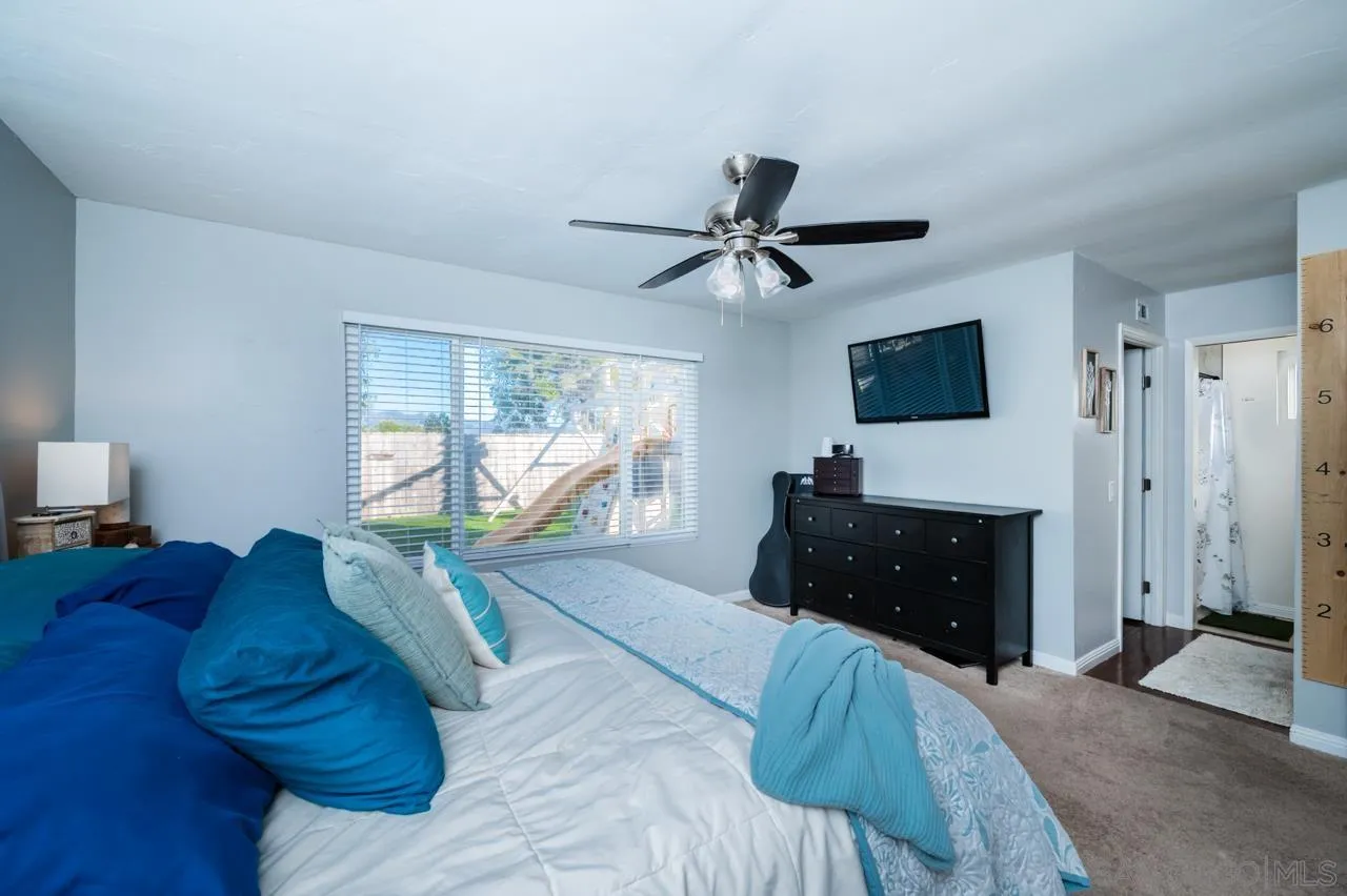14027 Hermosillo Way Poway, CA 92064 - Photo 22 of 31 a bed room with a bed a window and a television