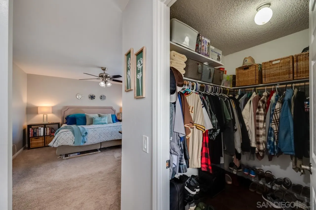 14027 Hermosillo Way Poway, CA 92064 - Photo 24 of 31 a view of walk in closet with clothes and shoes