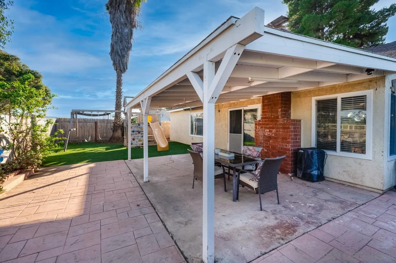 14027 Hermosillo Way Poway, CA 92064 - Photo 27 of 31 a view of a patio with table and chairs and floor to ceiling window