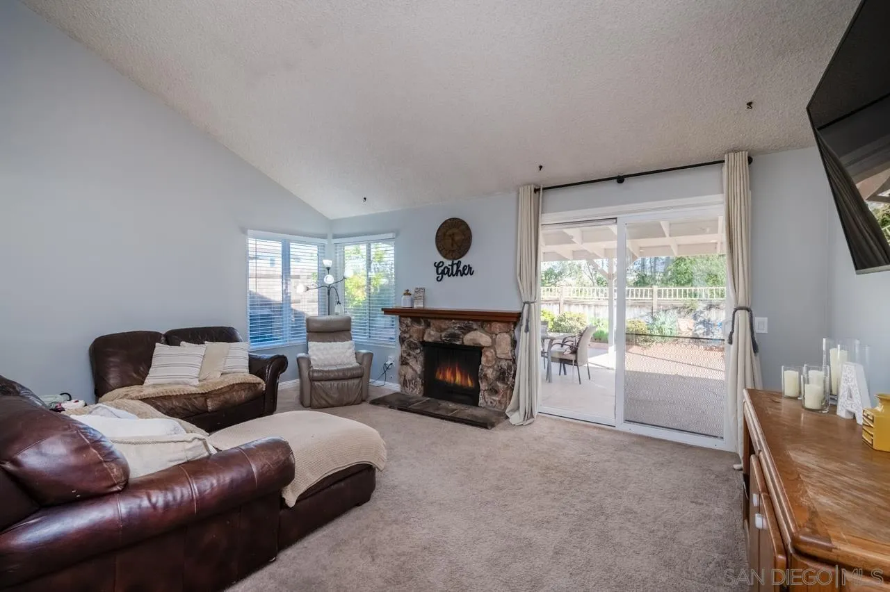 14027 Hermosillo Way Poway, CA 92064 - Photo 4 of 31 a living room with furniture and a fireplace