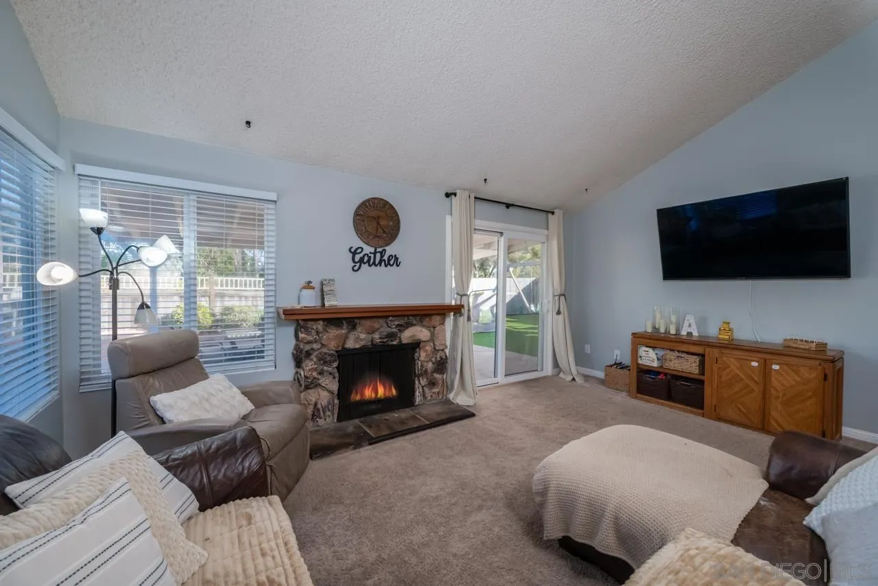 14027 Hermosillo Way Poway, CA 92064 - Photo 5 of 31 a living room with furniture and a flat screen tv