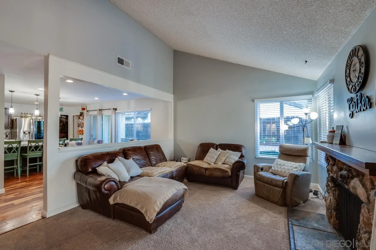 14027 Hermosillo Way Poway, CA 92064 - Photo 6 of 31 a living room with furniture and a fireplace