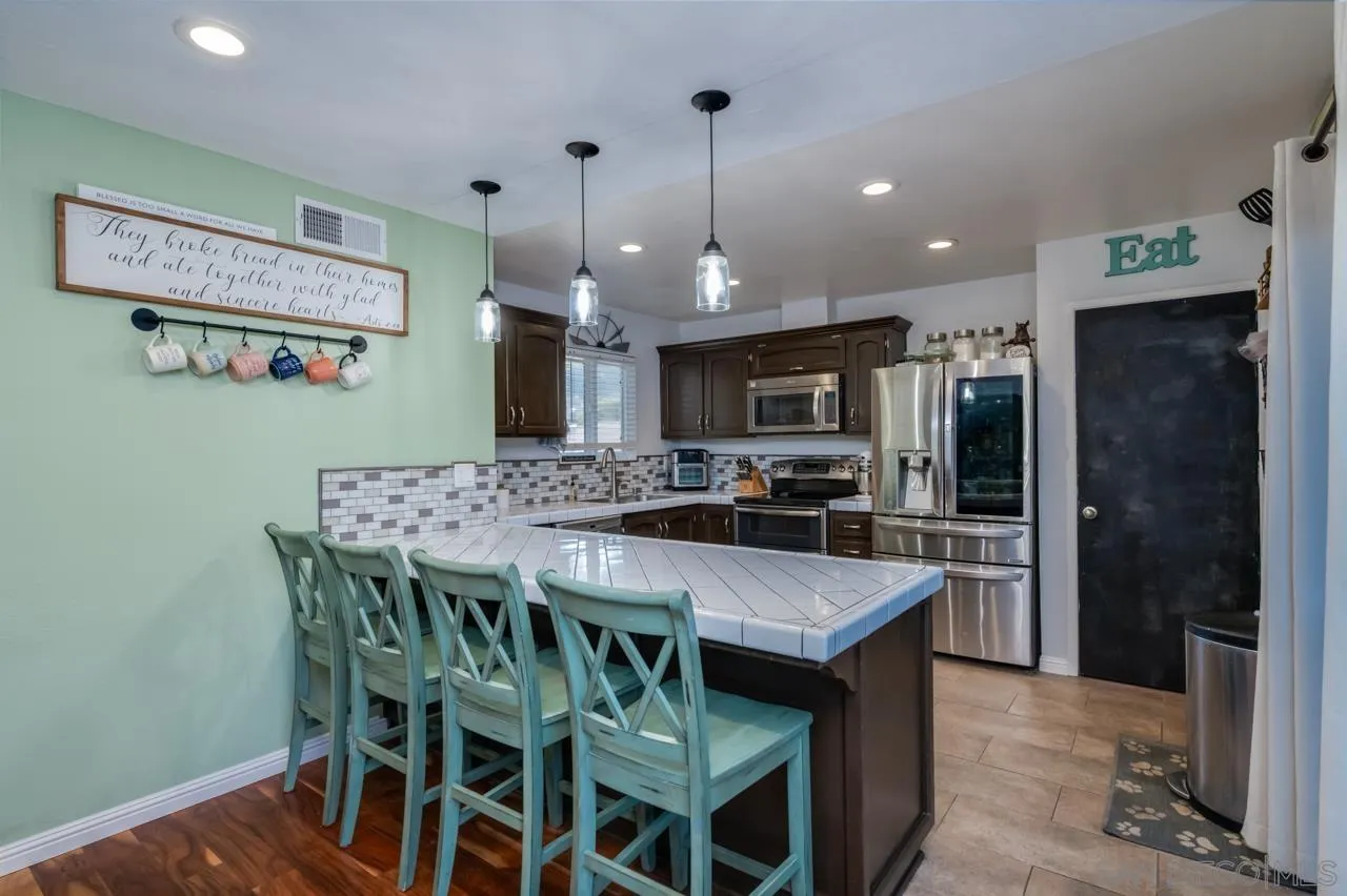 14027 Hermosillo Way Poway, CA 92064 - Photo 9 of 31 a kitchen with a table and chairs in it