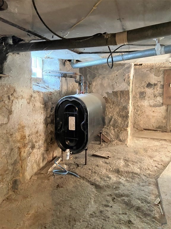 171 Snell Street Fall River, MA 02721 - Photo 28 of 34 a room with water heater and a wooden door