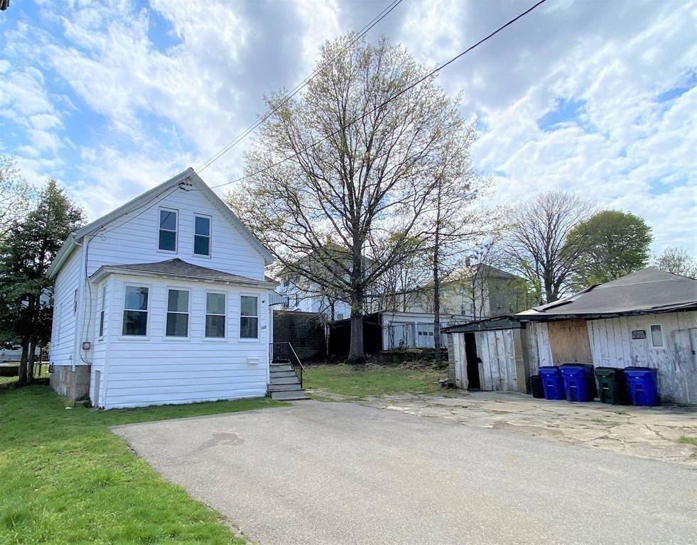171 Snell Street Fall River, MA 02721 - Photo 34 of 34 a front view of a house with a yard and garage