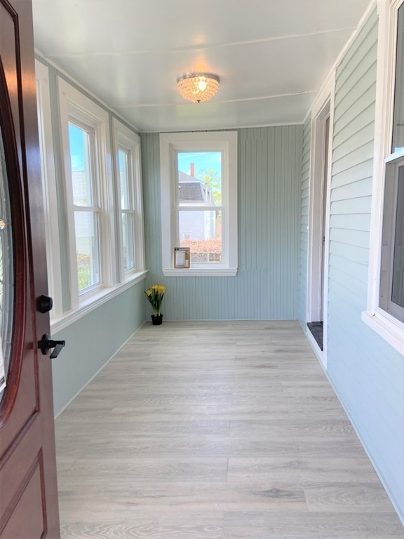 171 Snell Street Fall River, MA 02721 - Photo 4 of 34 a view of an empty room with a window and hardwood floor