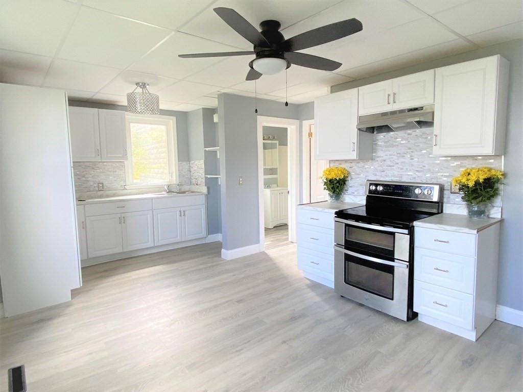 171 Snell Street Fall River, MA 02721 - Photo 8 of 34 a kitchen with stainless steel appliances granite countertop a stove and a refrigerator